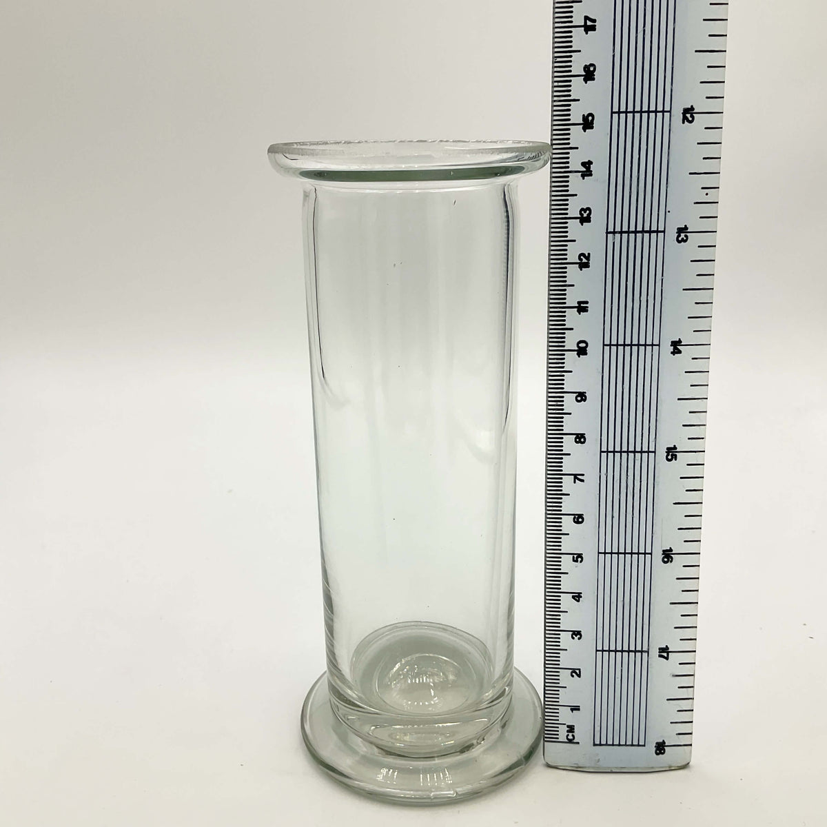 Vintage Cylinder Clear Glass Vase by Beeches Vintage, showcasing a tall, elegant glass vase with a smooth, transparent surface.