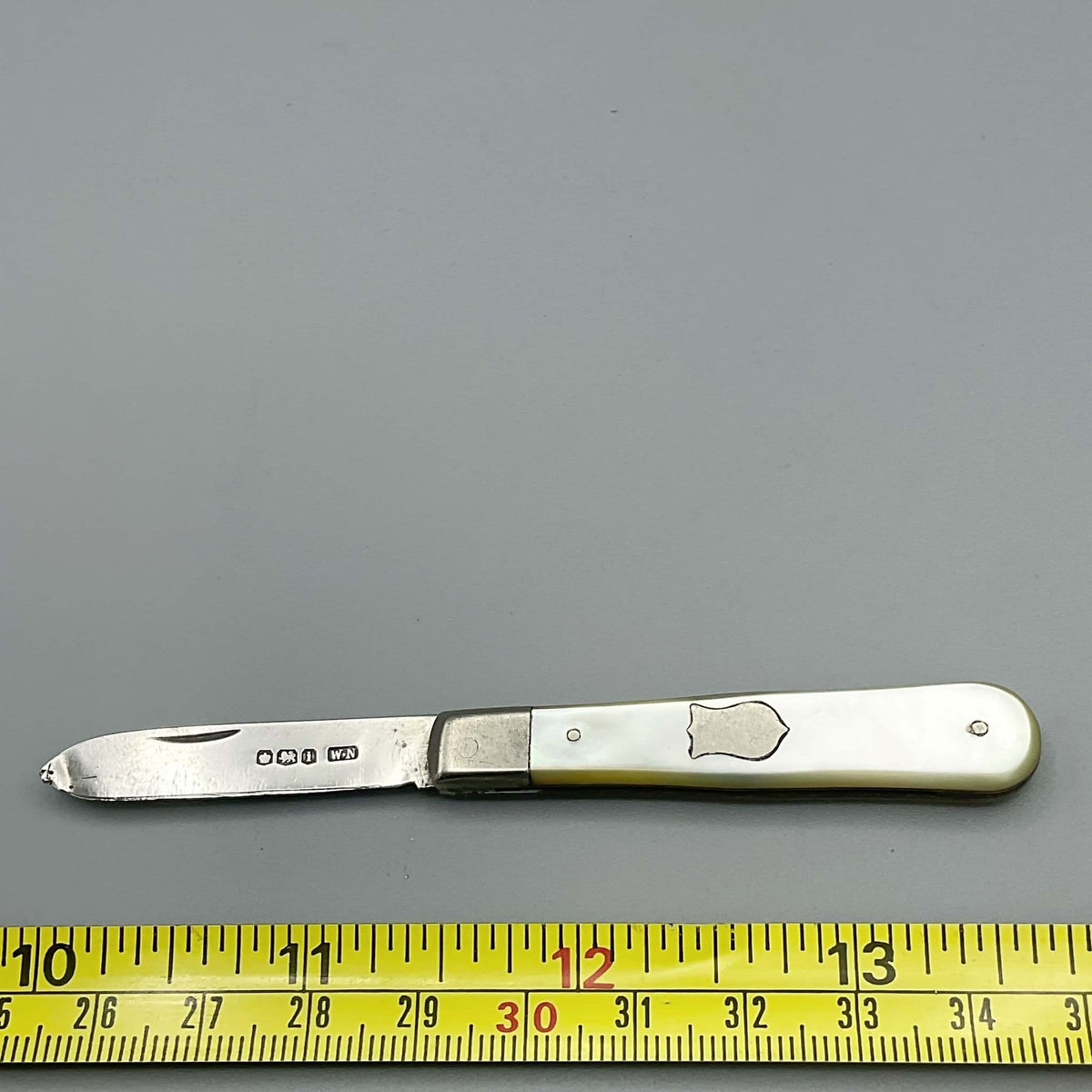 Sterling silver fruit knife with a mother-of-pearl handle and 1926 Beeches Vintage hallmark.