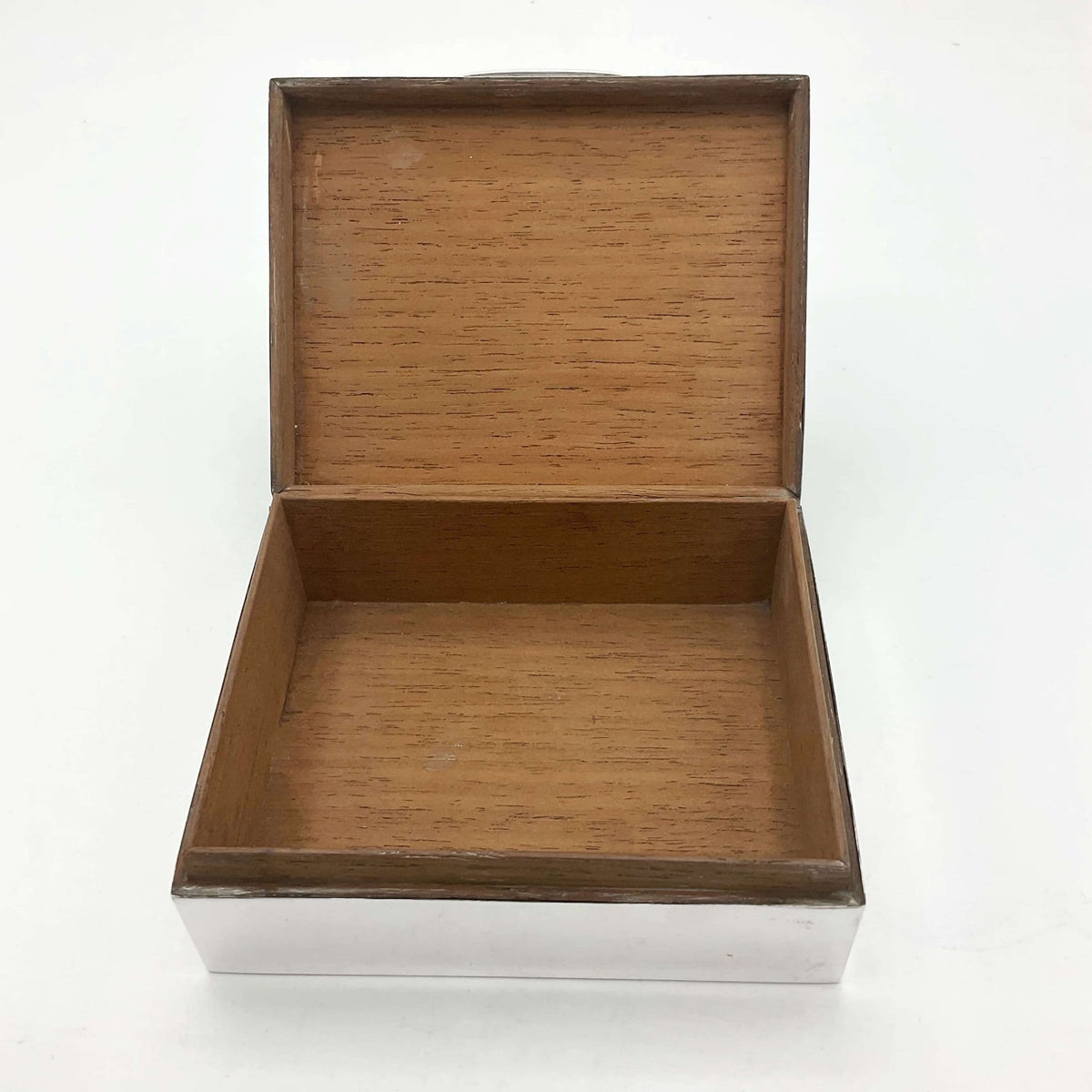 Cedar wood lined interior of 1920s silver cigarette box