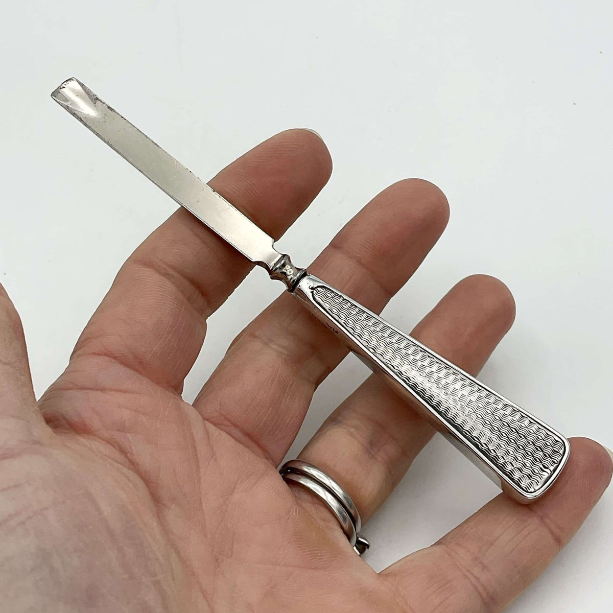 Vintage cuticle pusher held in a hand