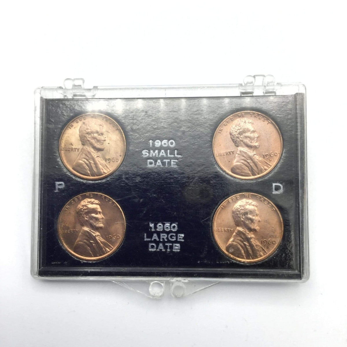 Set of four coins in a display case with '1960' text on a white background