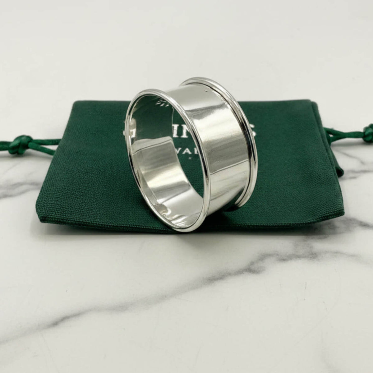 1962 Sterling Silver Napkin Ring on a green cloth bag
