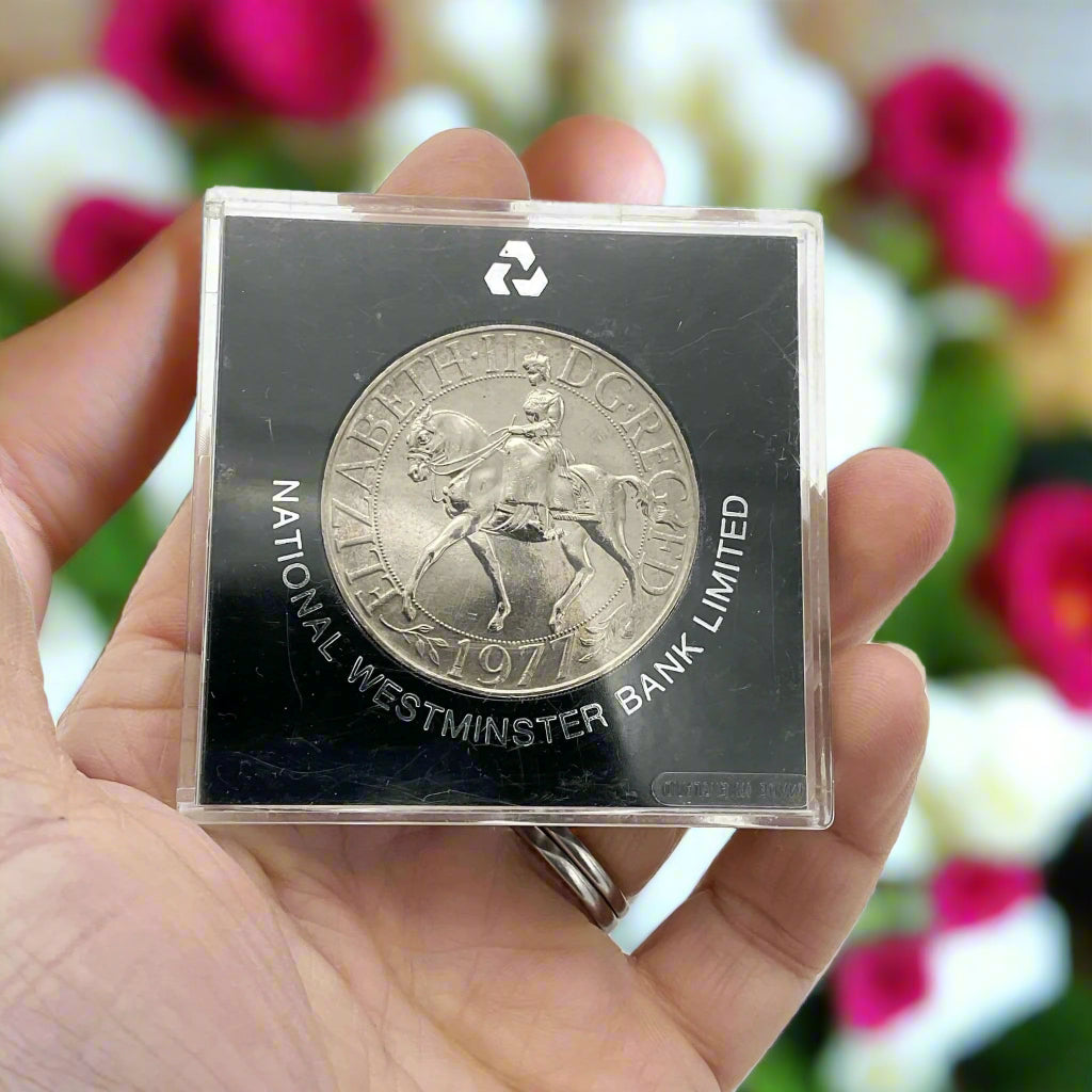 silver crown coin in a black case with HM Queen Elizabeth II Jubliee Crown reverse side held in a hand