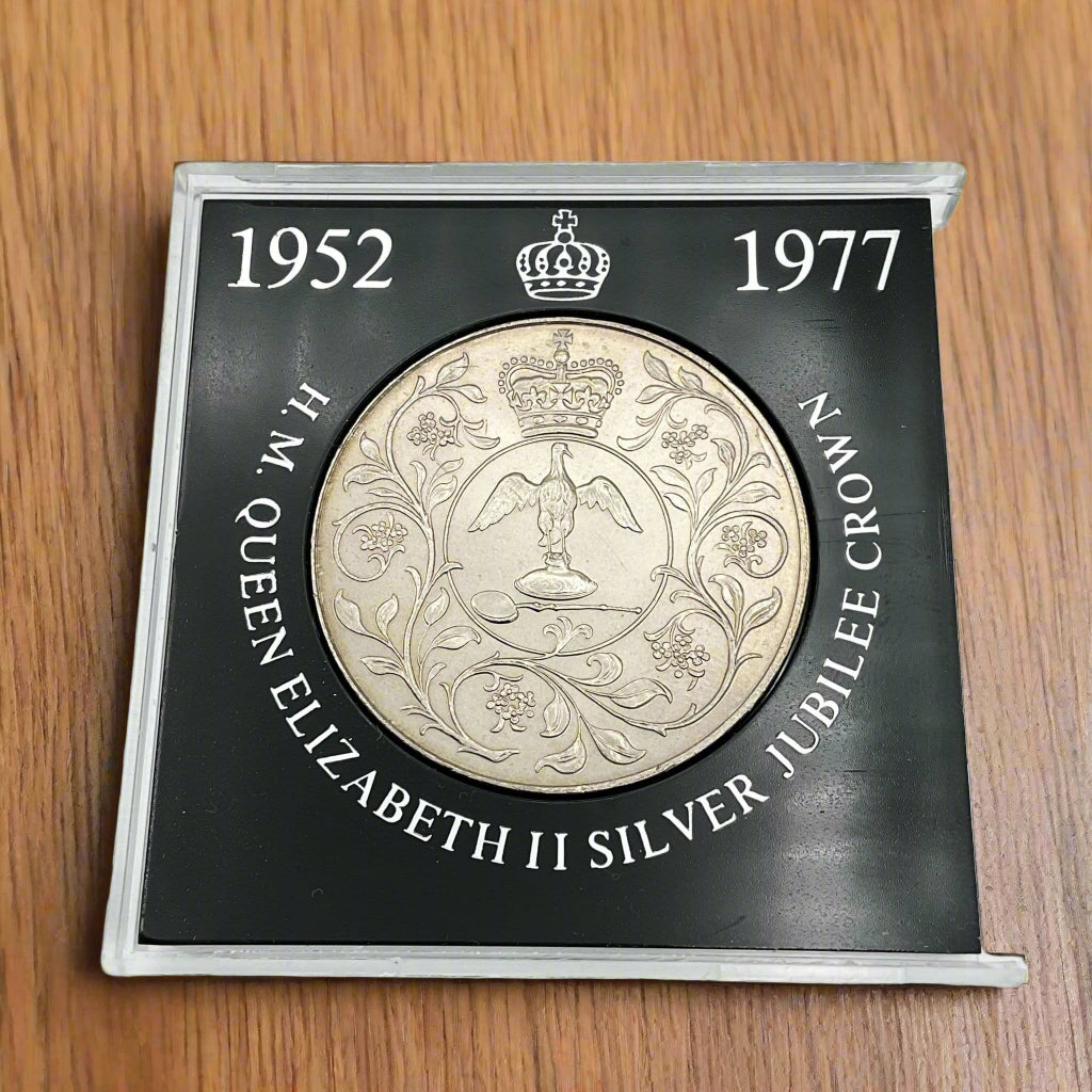 silver crown coin in a black case with HM Queen Elizabeth II Jubliee Crown with the perspex cover removed
