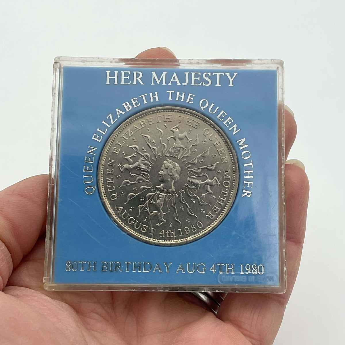 1970s Queen Mother 80th birthday commemorative coin by Beeches Vintage, featuring a detailed portrait of the Queen Mother.