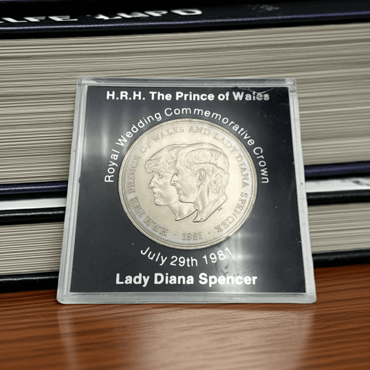 Royal wedding commemorative coin in a clear case with text on a wooden surface