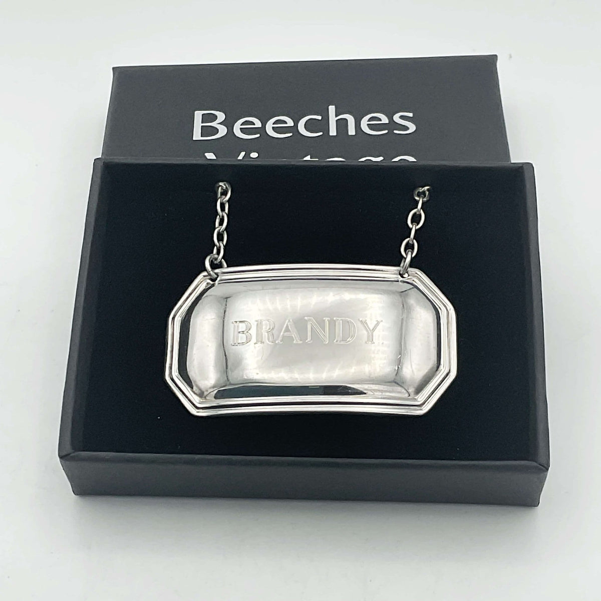 Sterling silver vintage 1983 Brandy decanter label by Beeches Vintage, featuring engraved detailing and classic design.