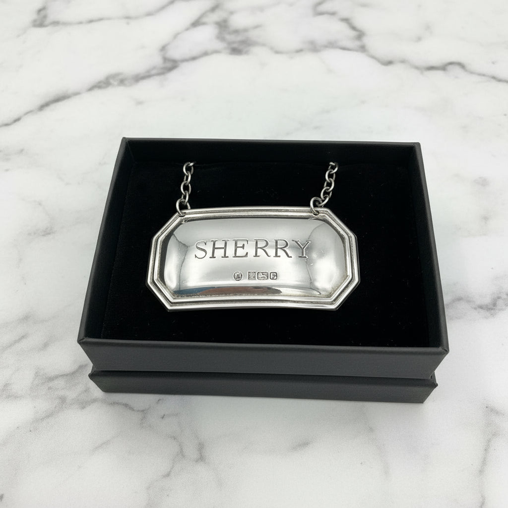 Sherry decanter label in a black gift box on a marble worktop