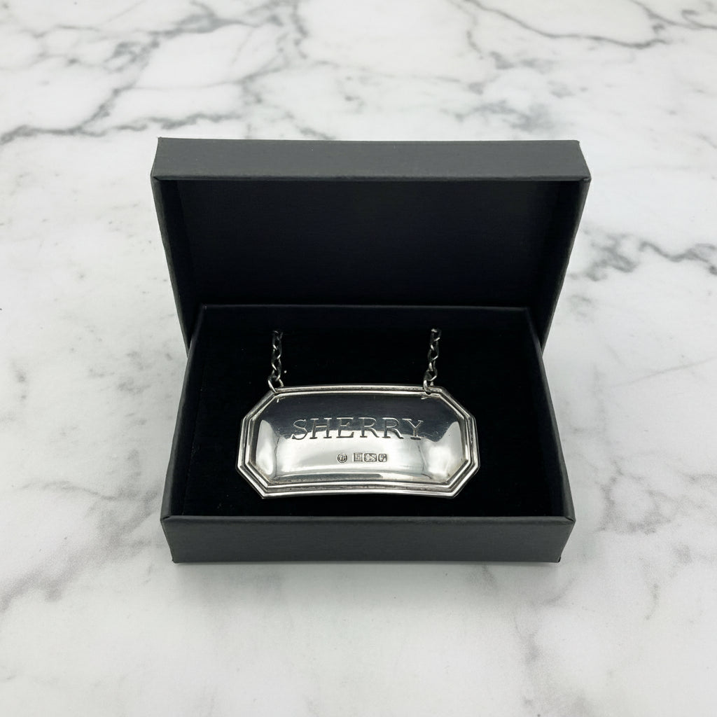 Sherry decanter label in a black presentation box on a marble worktop