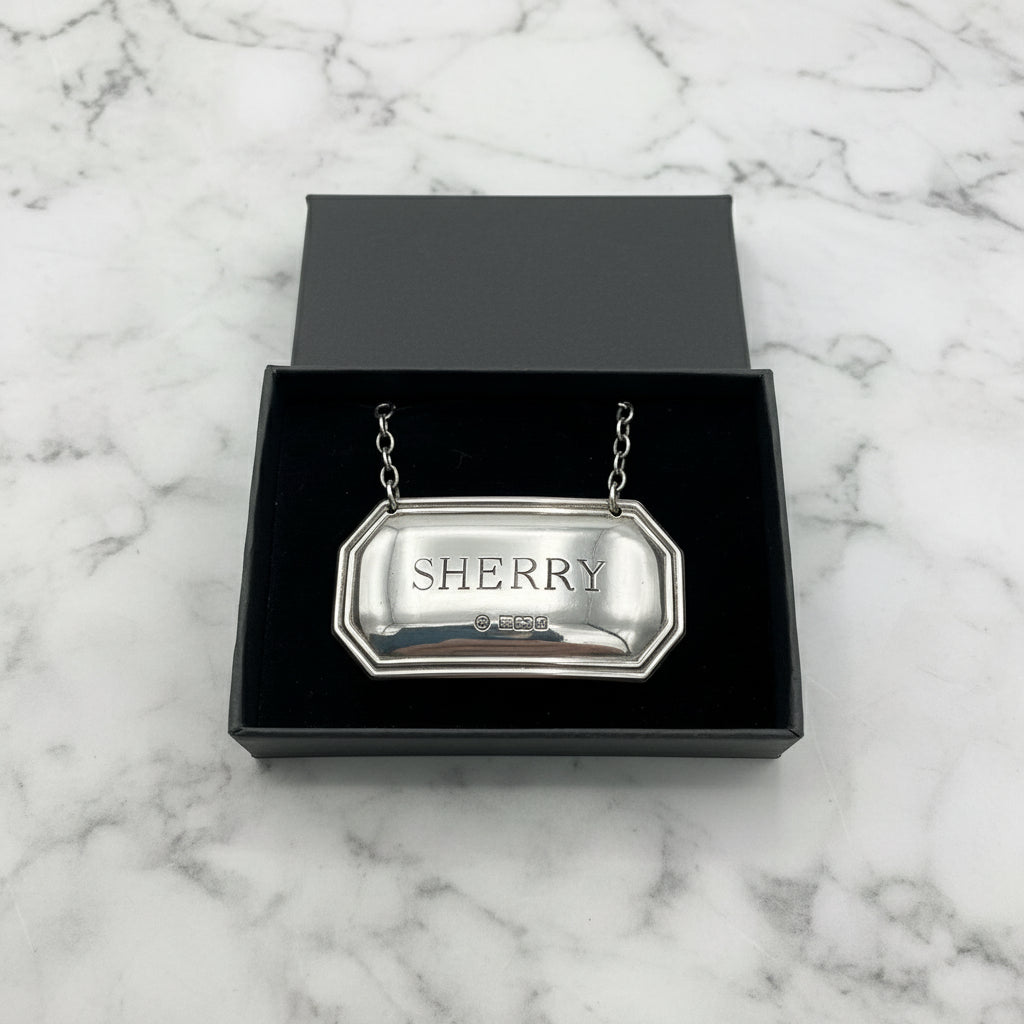 Sherry decanter label in a black presentation box on a marble worktop