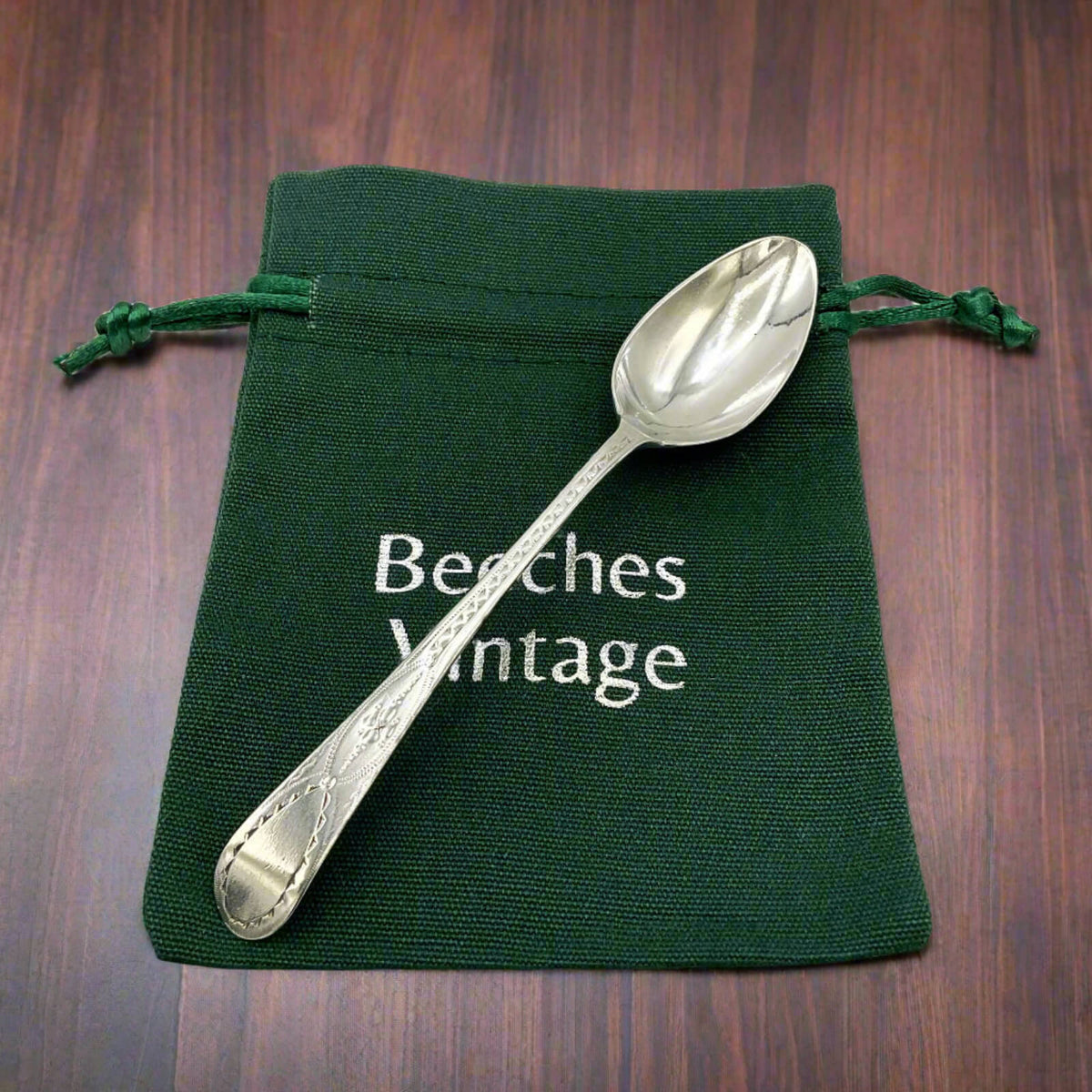 Antique 1793 Georgian Sterling Silver Teaspoon on a green bag