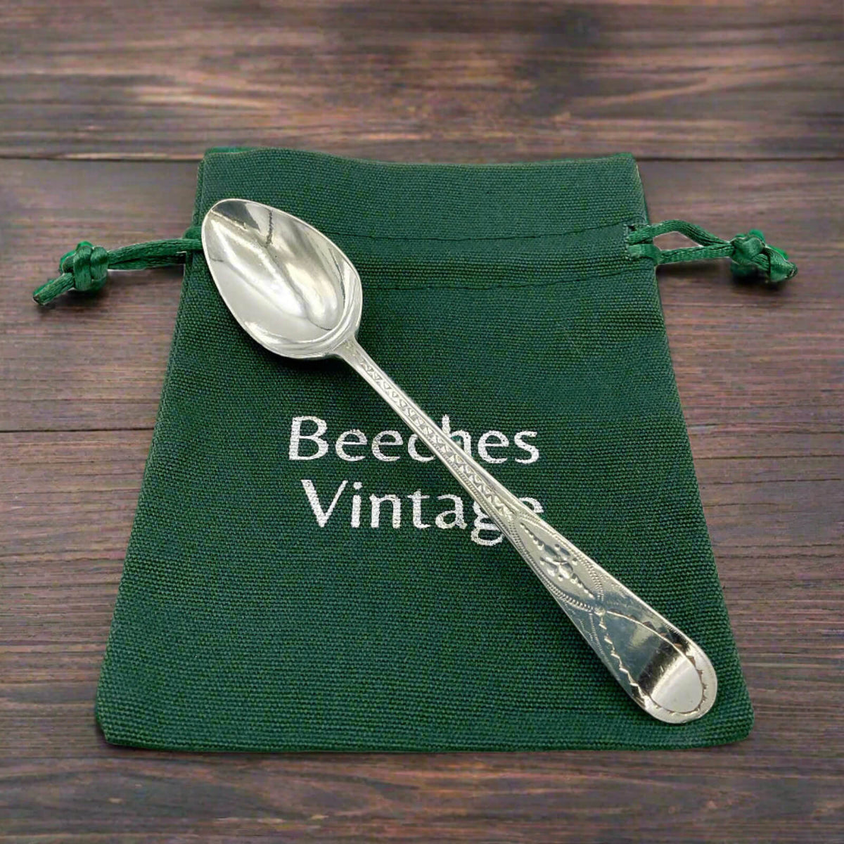 Antique 1793 Georgian Sterling Silver Teaspoon on a green bag