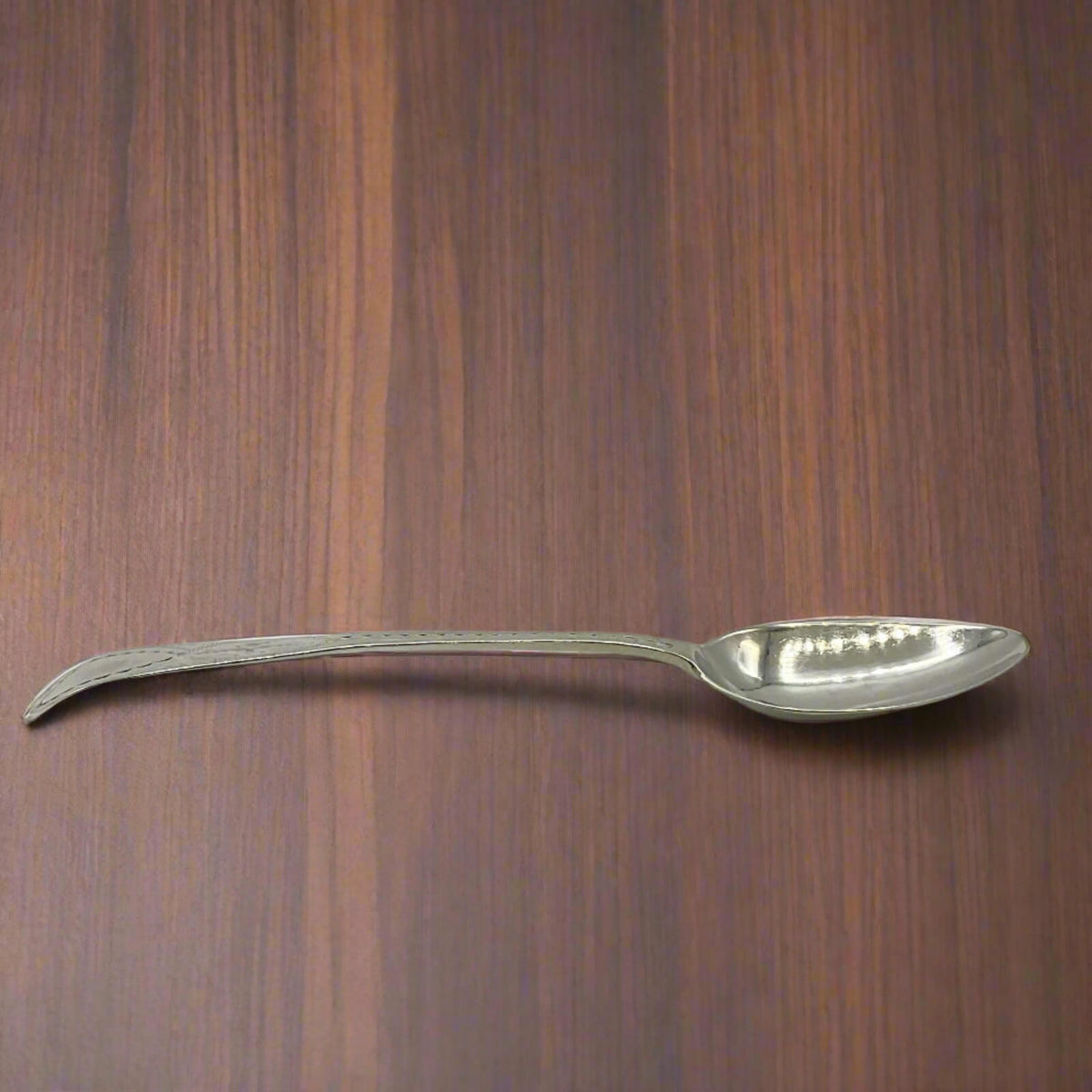Silver spoon on a wooden surface