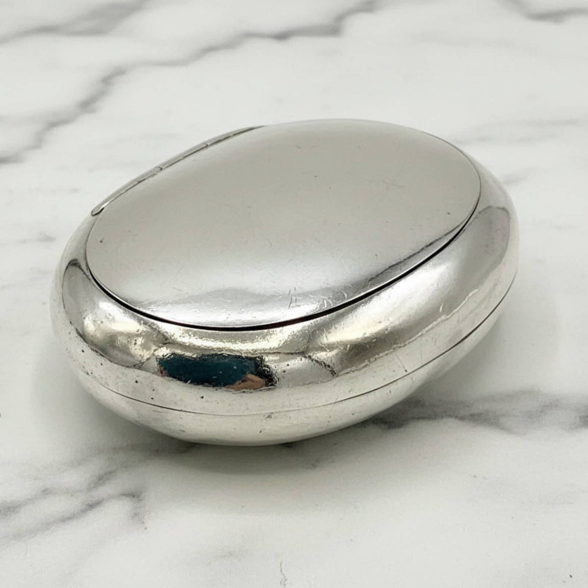 Silver box on a marble surface