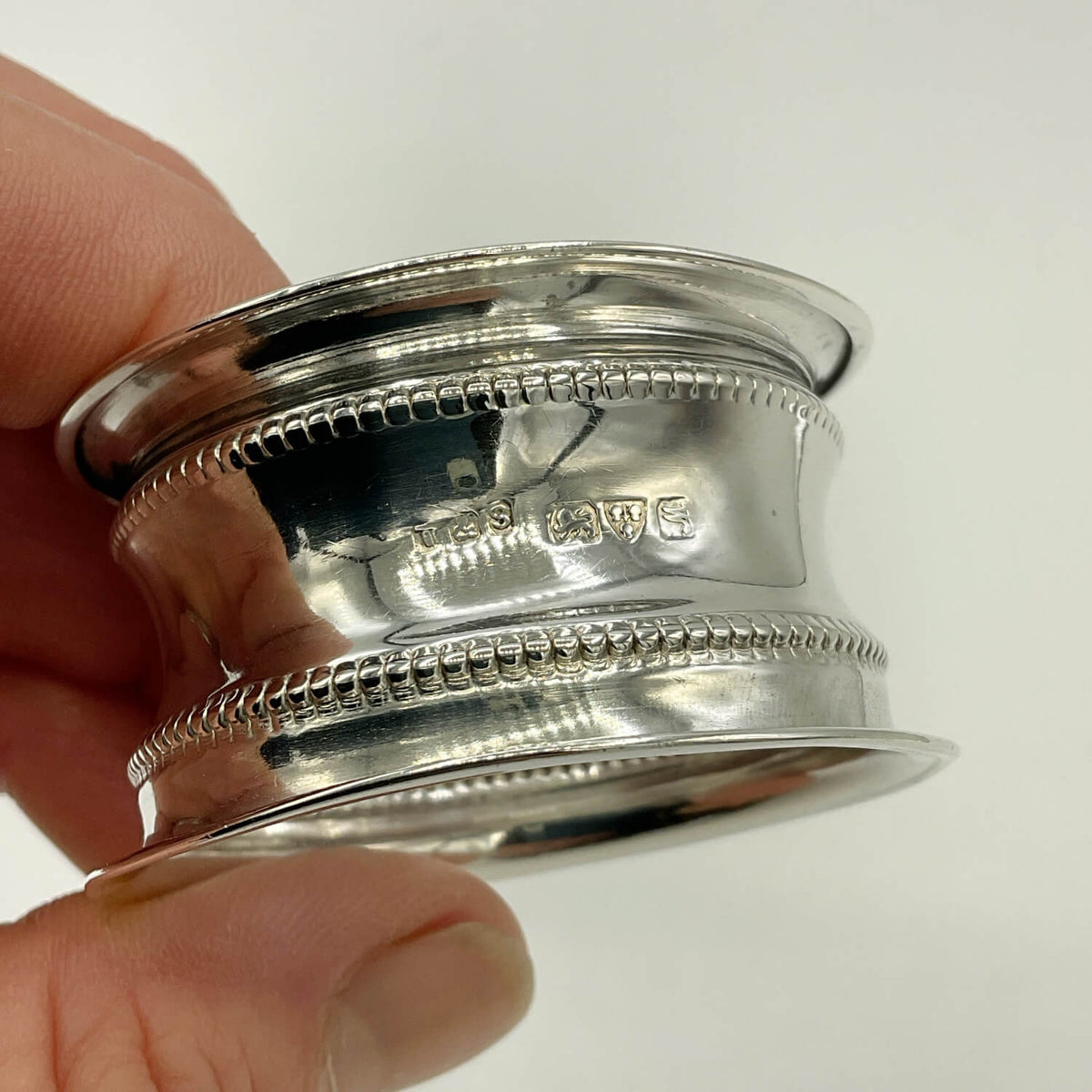 Antique 1912 Sterling Silver Napkin Ring with hallmarks held in hands