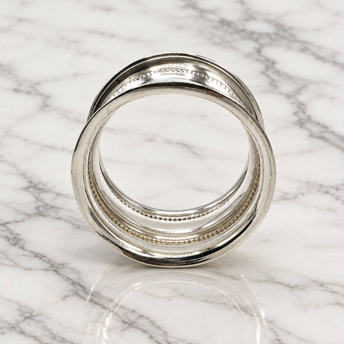 Antique 1912 Sterling Silver Napkin Ring on marble