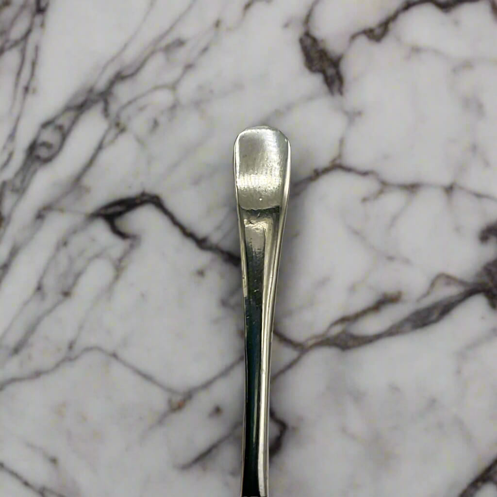 Silver spoon on a marble surface