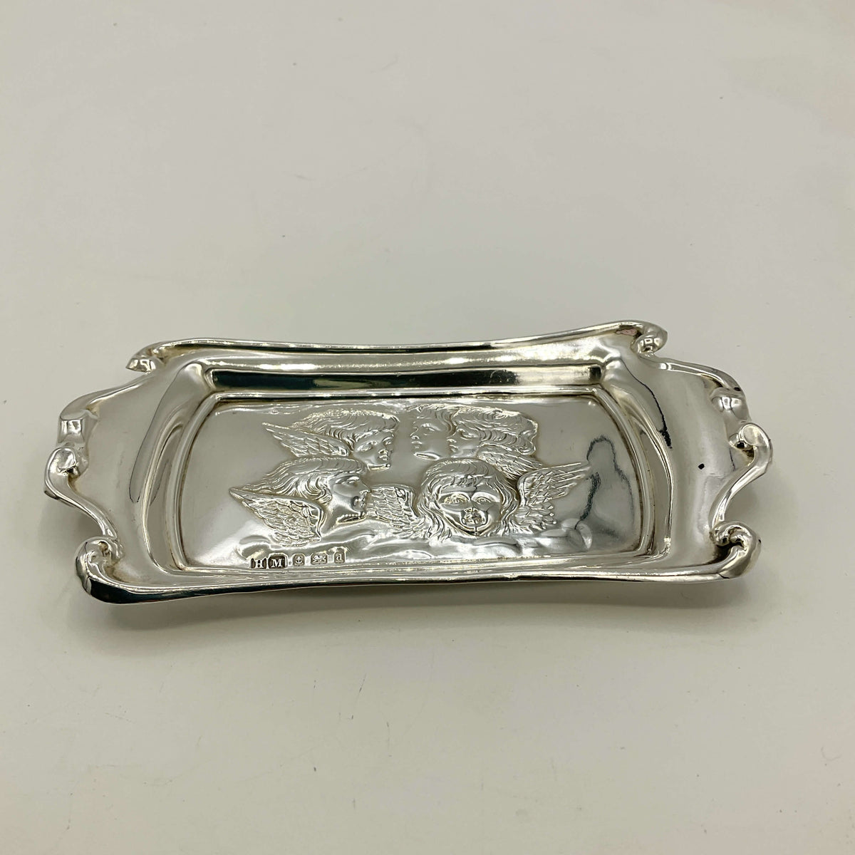 Silver tray with engraved design on a white background
