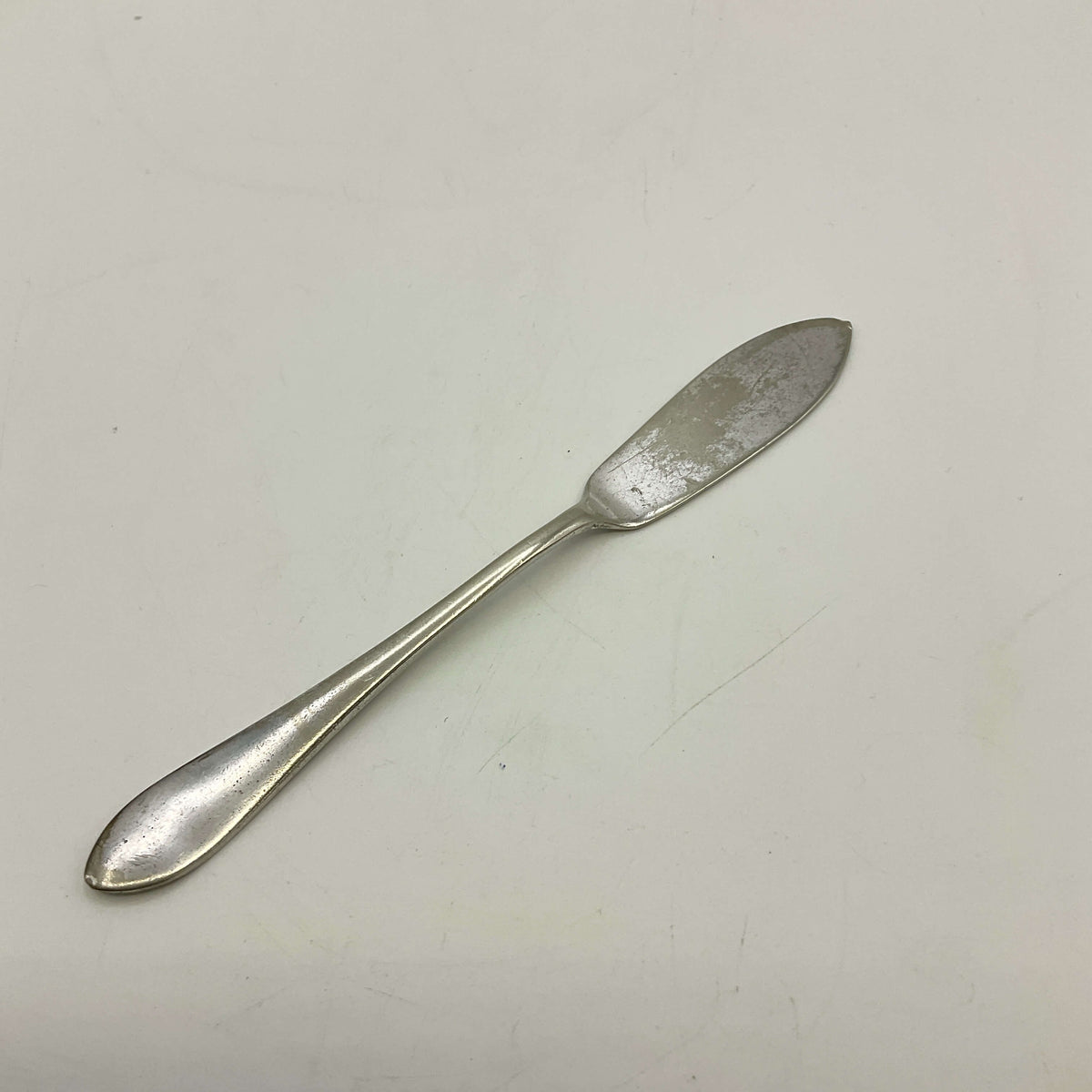 Silver butter knife on a white background