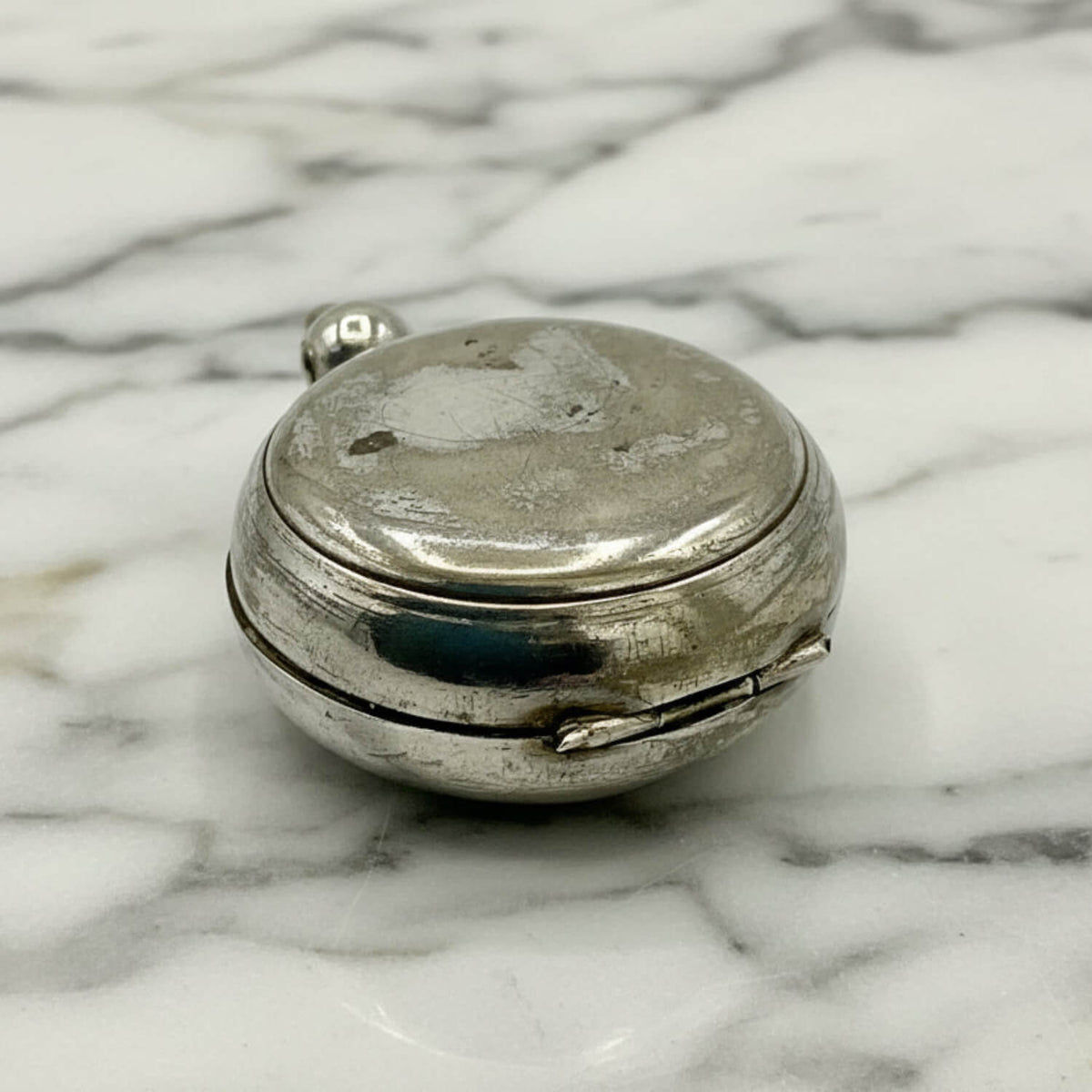 Antique Silver Plated Sovereign Case on a marble surface