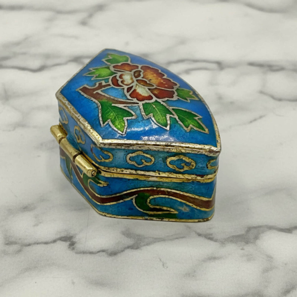 Chinese Cloisonné Enamel Pill Box side view on a marble surface