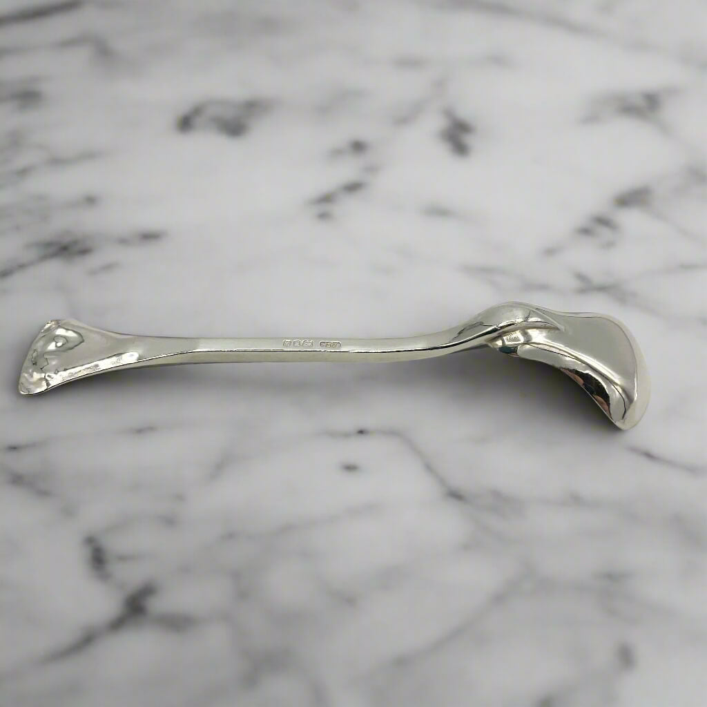 Silver spoon on a marble surface