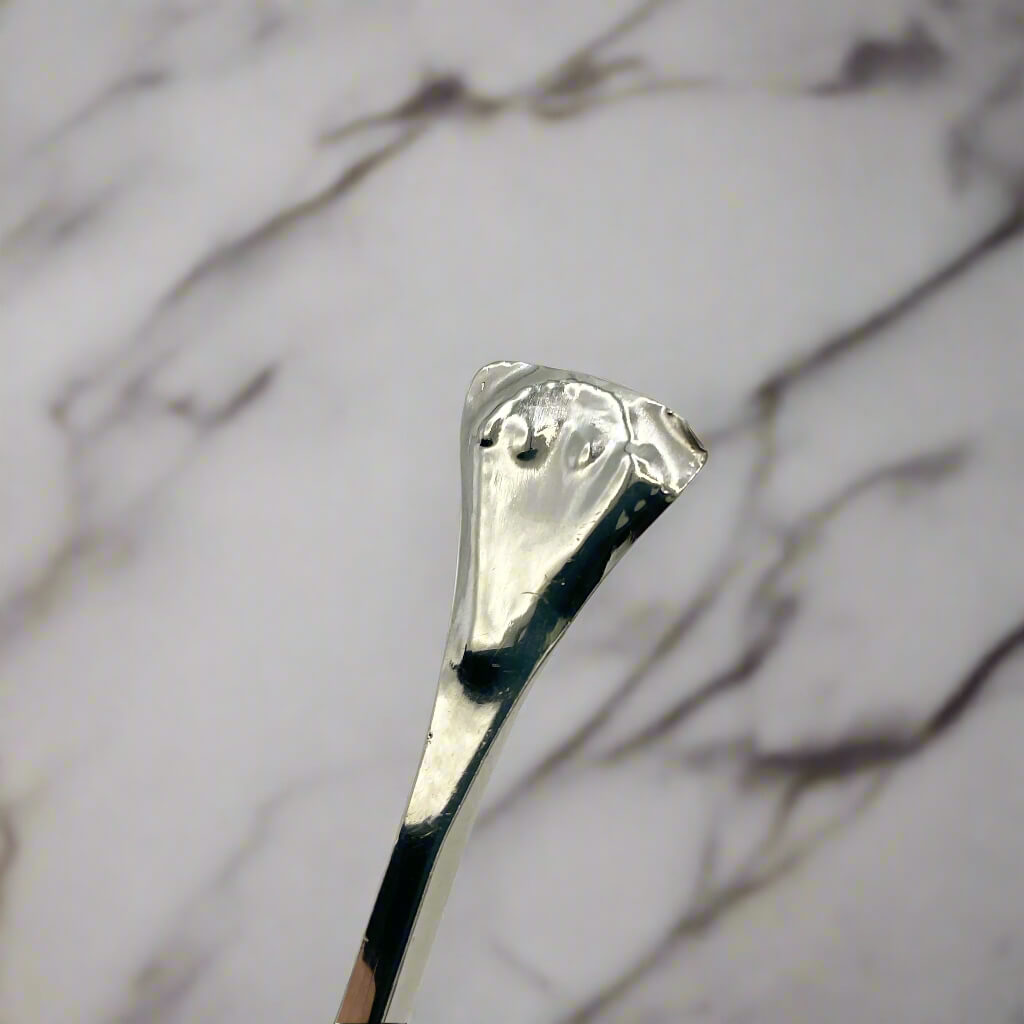 Silver spoon handle on a marble background
