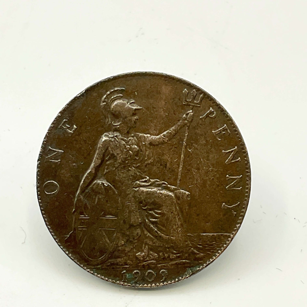 Antique one penny coin with Britannia on with a granite surface