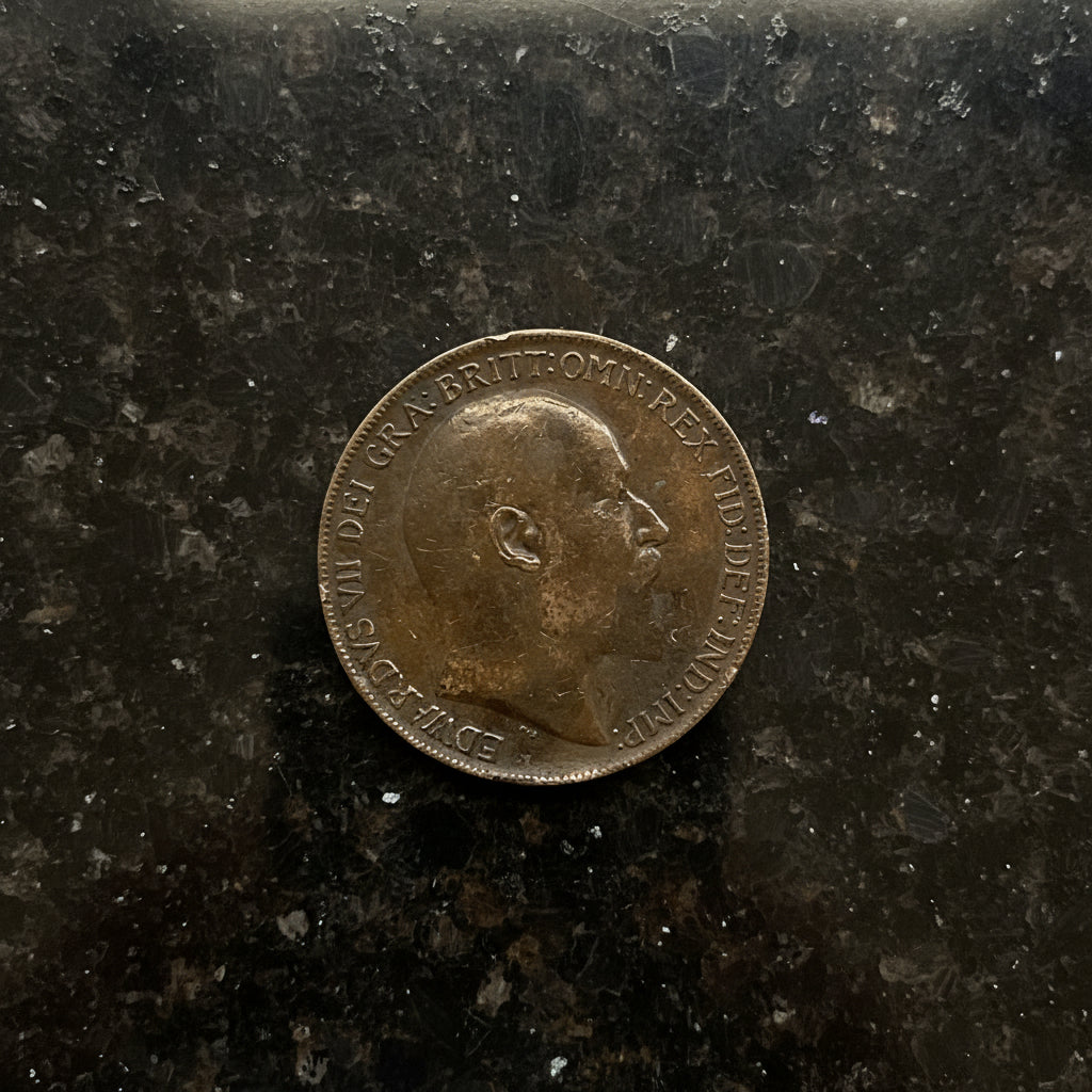 Antique one penny on dark granite 