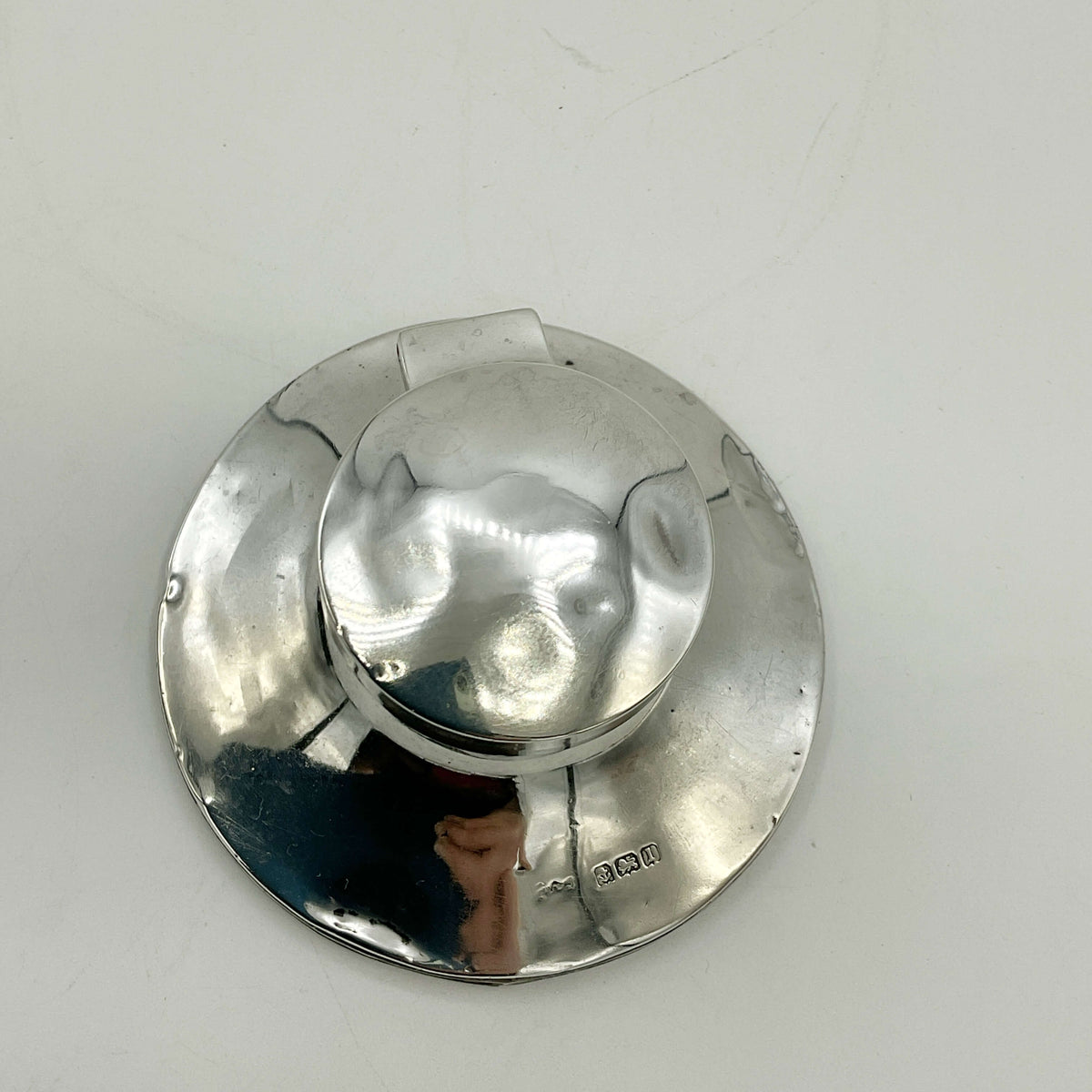 Antique small sterling silver inkwell with ornate design, vintage style, by Beeches Vintage, shown on a wooden surface.