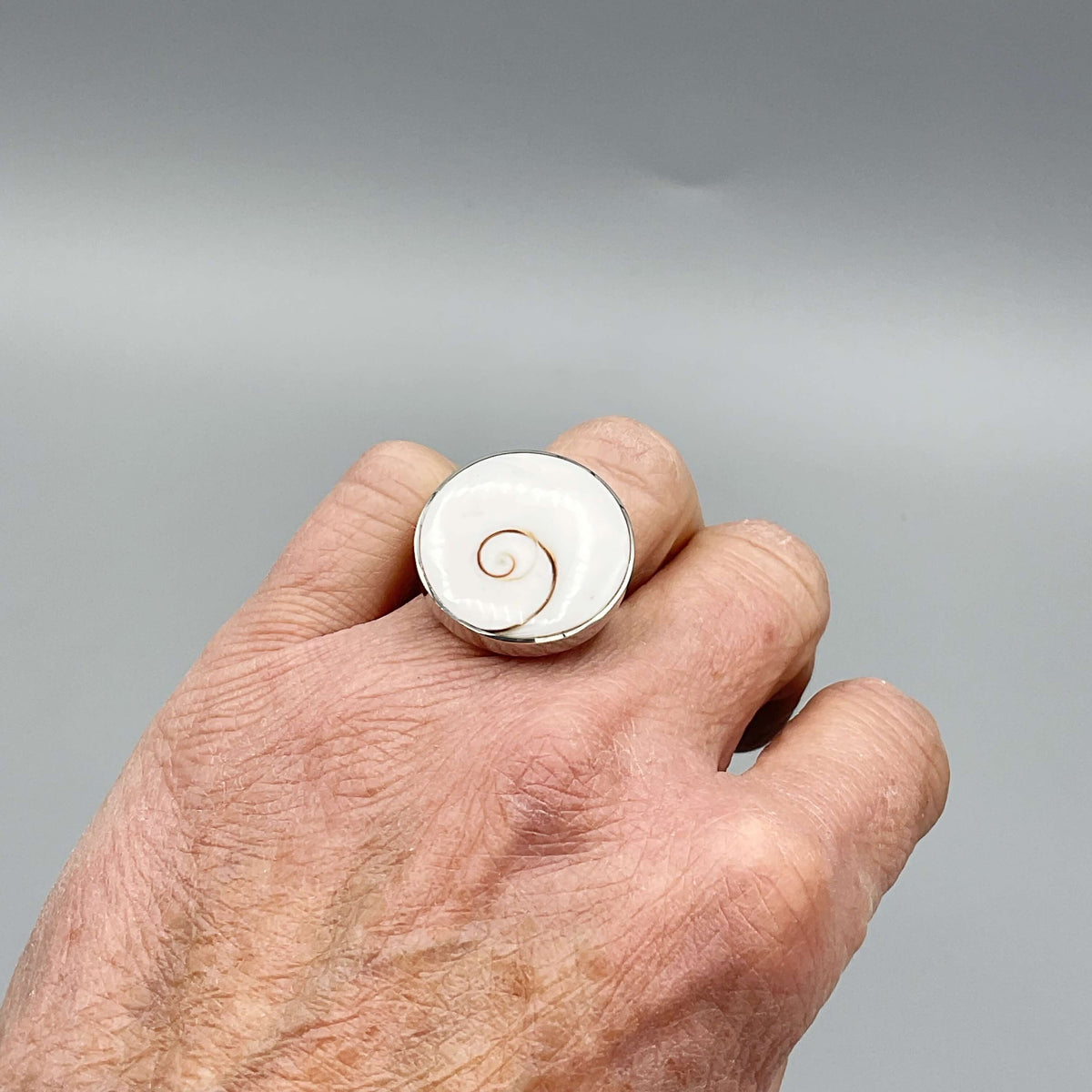 Silver enamel ring with intricate design from Beeches Vintage, showcasing a detailed decorative pattern on the ring.