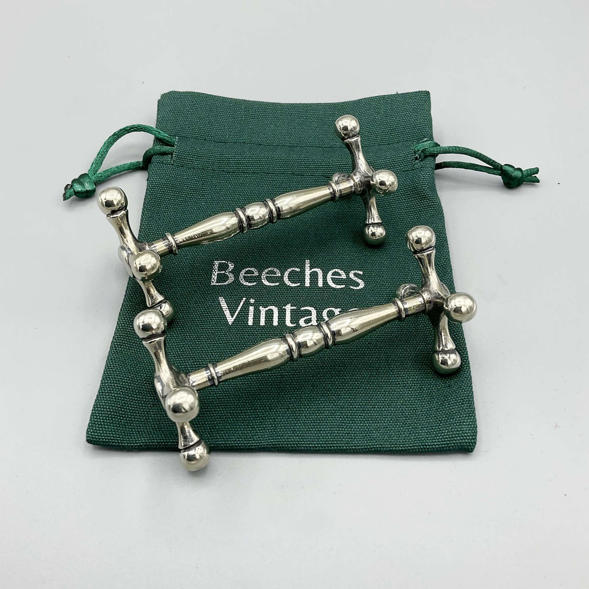 Antique Victorian silver-plated knife rests by Beeches Vintage, featuring intricate ornate design for elegant table settings.