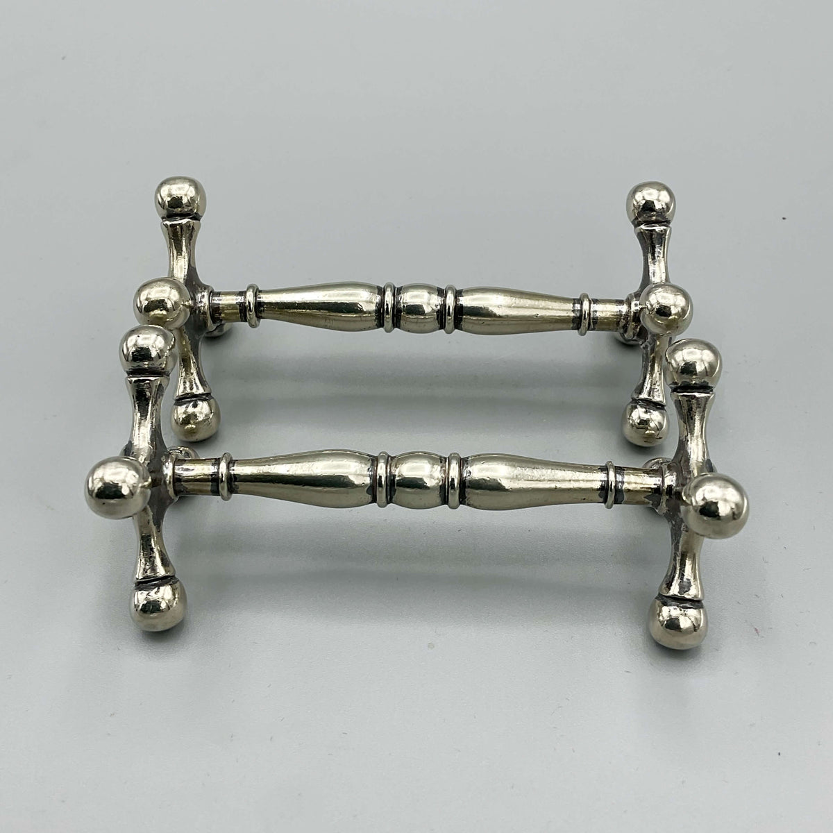Antique Victorian silver-plated knife rests with ornate detailing, crafted by Beeches Vintage for elegant table settings.