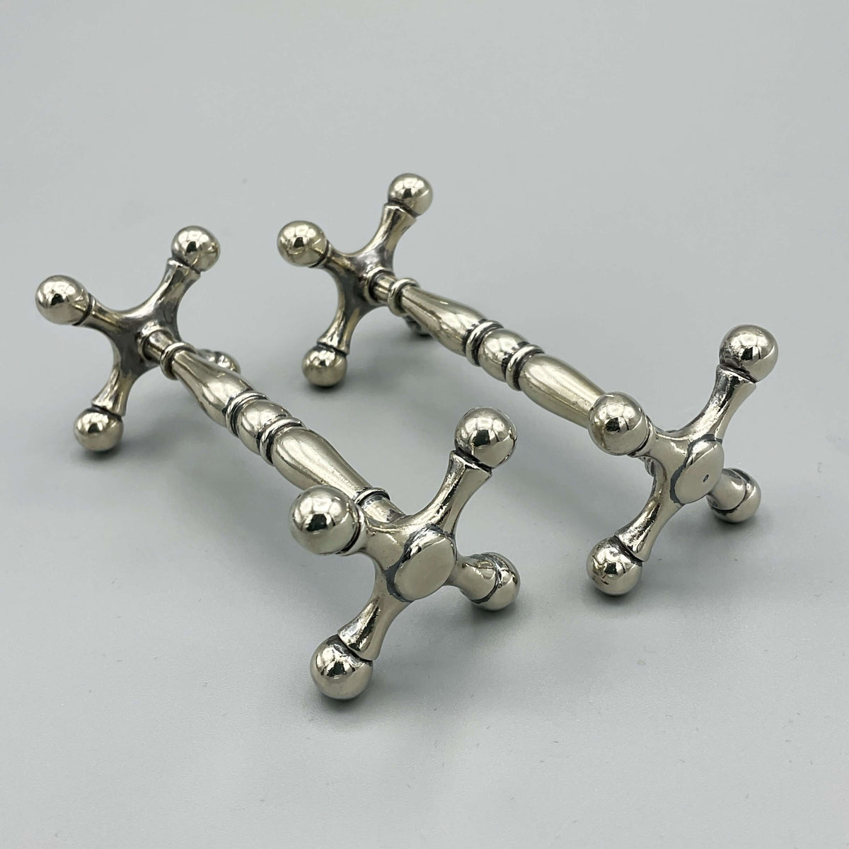 Antique Victorian silver-plated knife rests with intricate detailing, from Beeches Vintage, showcasing elegant tableware design.