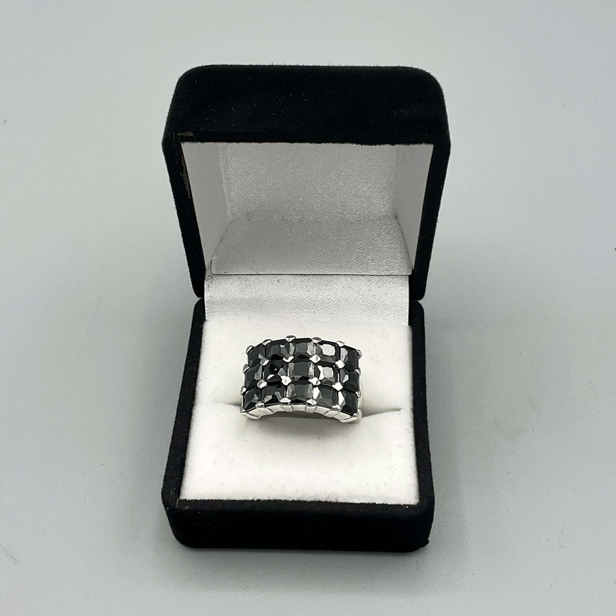 Black cubic zirconia silver ring with a vintage design by Beeches Vintage, featuring a sparkling central stone and intricate band.