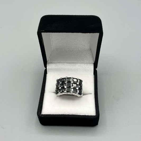 Black cubic zirconia silver ring with a vintage design by Beeches Vintage, featuring a sparkling central stone and intricate band.