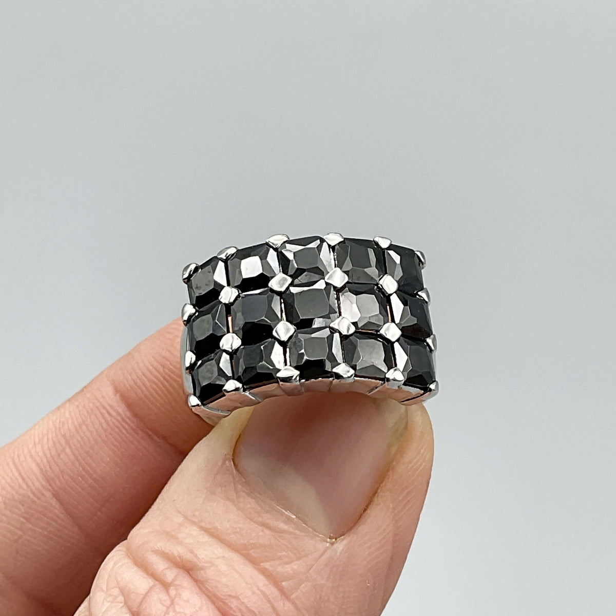 Silver ring with black cubic zirconia stones by Beeches Vintage, showcasing a detailed design and sparkling gemstone accents.