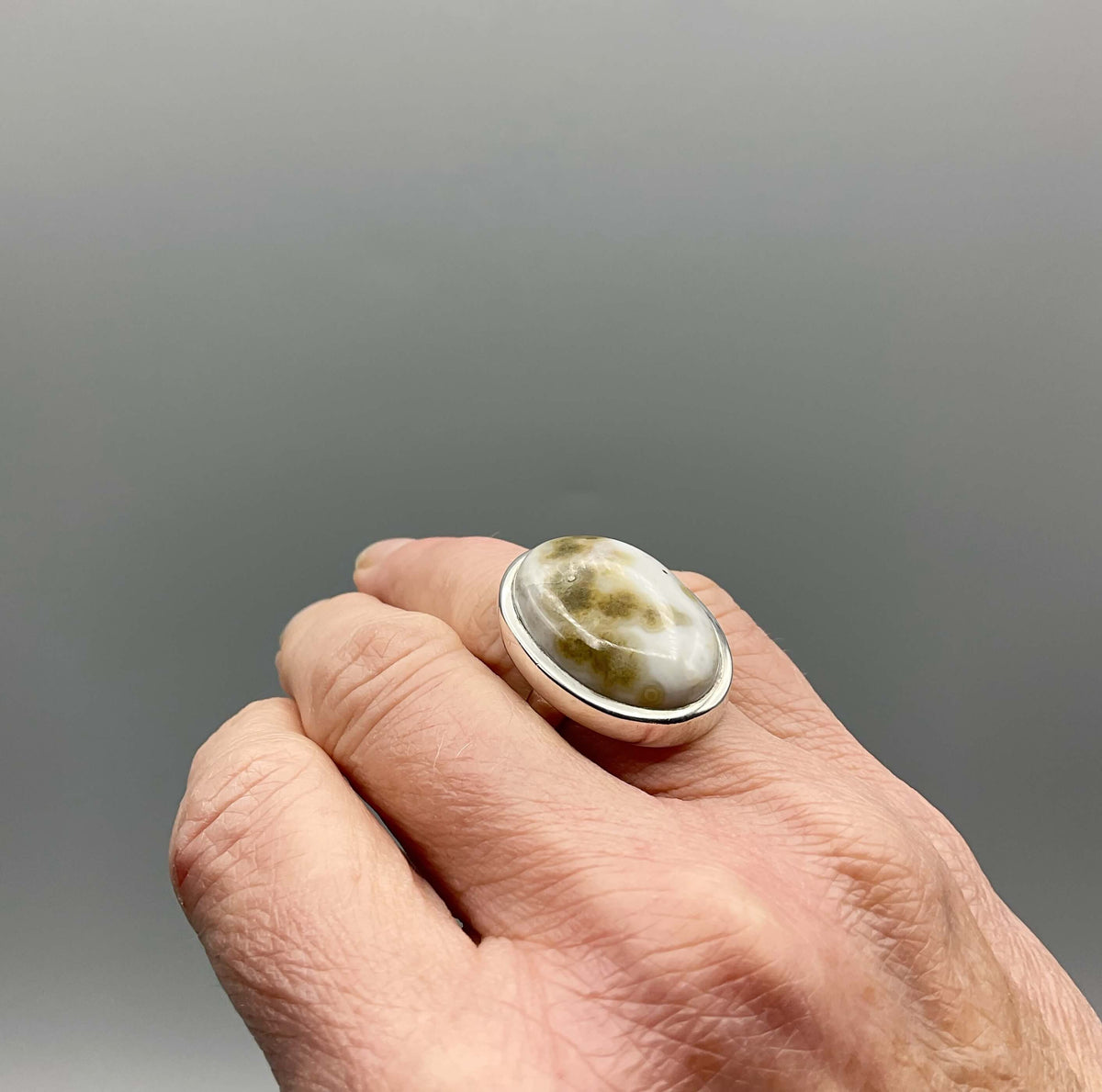 Beeches Vintage Moss Agate ring featuring a polished oval gemstone set in a detailed metal band.