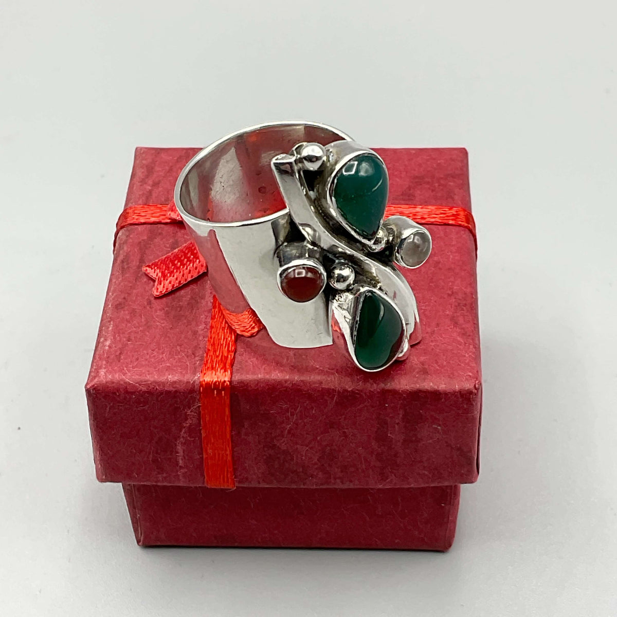 Multicoloured agate silver ring with intricate band design, crafted by Beeches Vintage, showcasing vibrant gemstone and elegant silver setting.