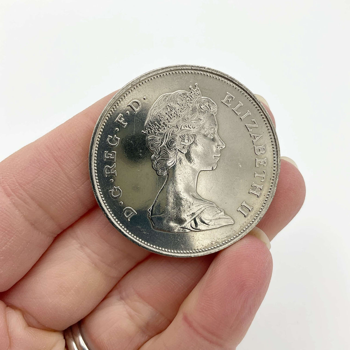 Charles and Diana 1981 Royal Wedding coin by Beeches Vintage, featuring detailed images of the coin's design and markings.
