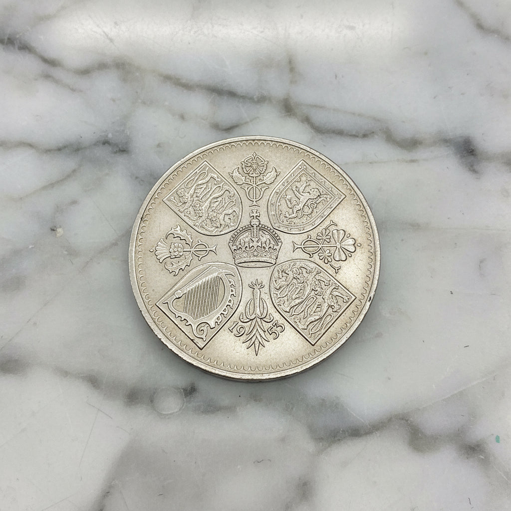 1953 Queen Elizabeth II Coronation Coin on a marble surface