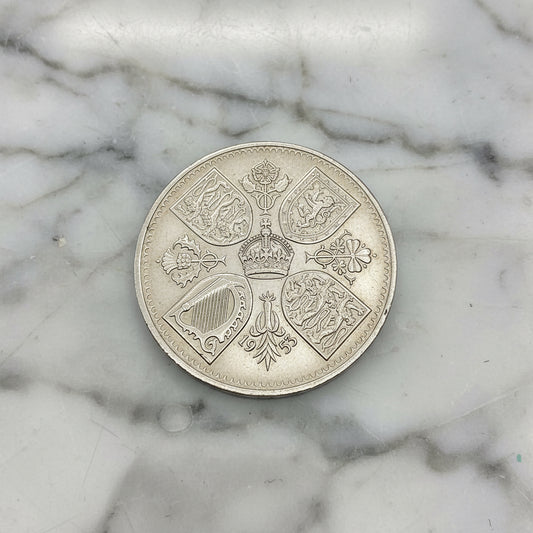 1953 Queen Elizabeth II Coronation Coin on a marble surface