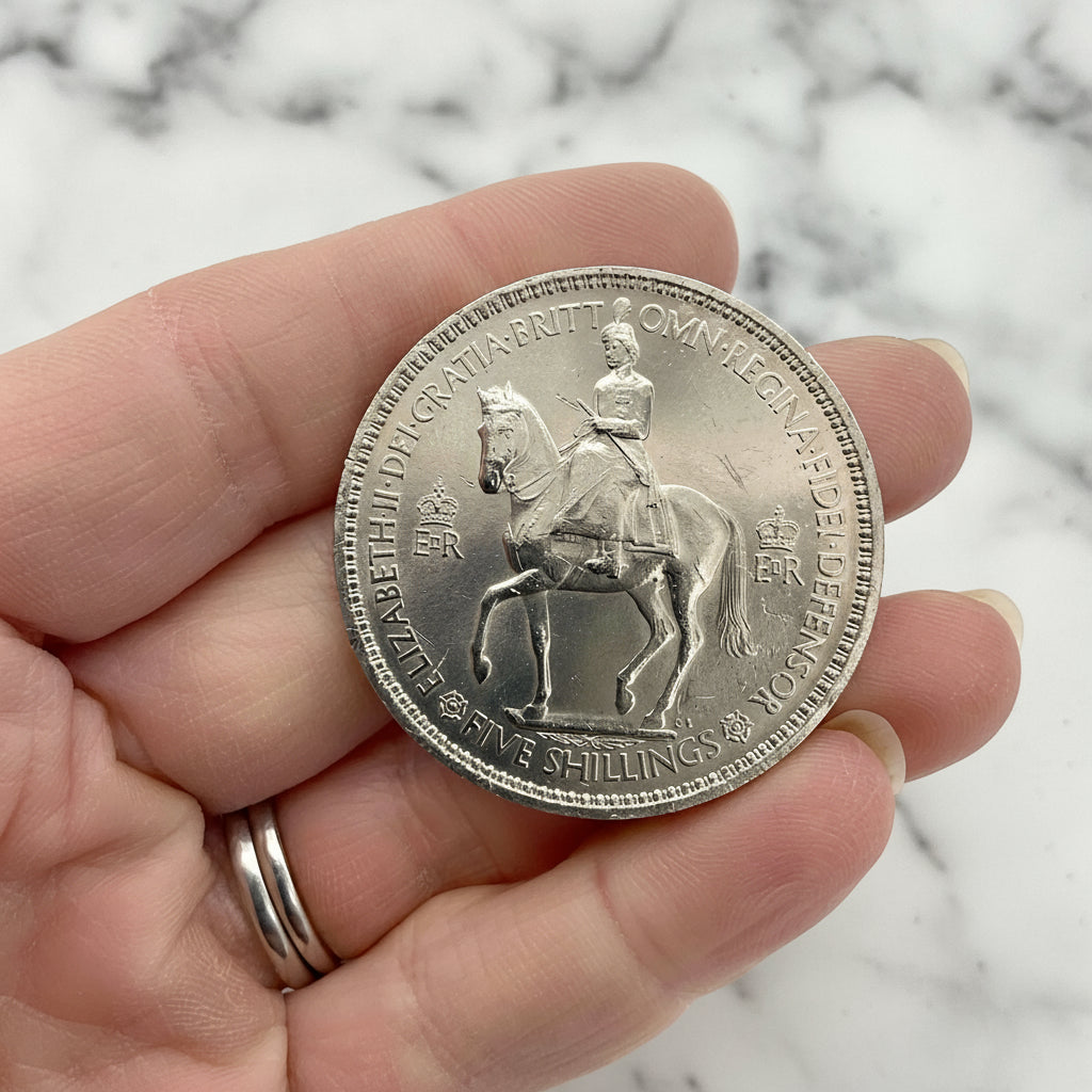 Reverse of 1953 Queen Elizabeth II Coronation Coin held in hand