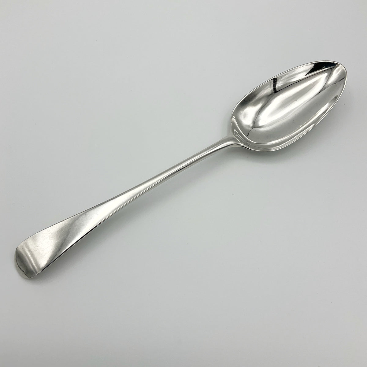 Antique Georgian 1788 silver serving spoon with intricate handle, from Beeches Vintage, showcasing detailed craftsmanship.