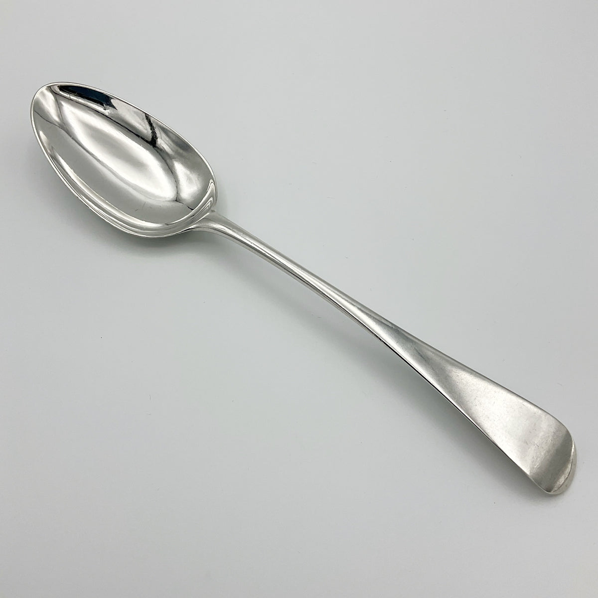 Antique Georgian 1788 silver serving spoon with intricate handle, crafted by Beeches Vintage, classic vintage tableware piece.