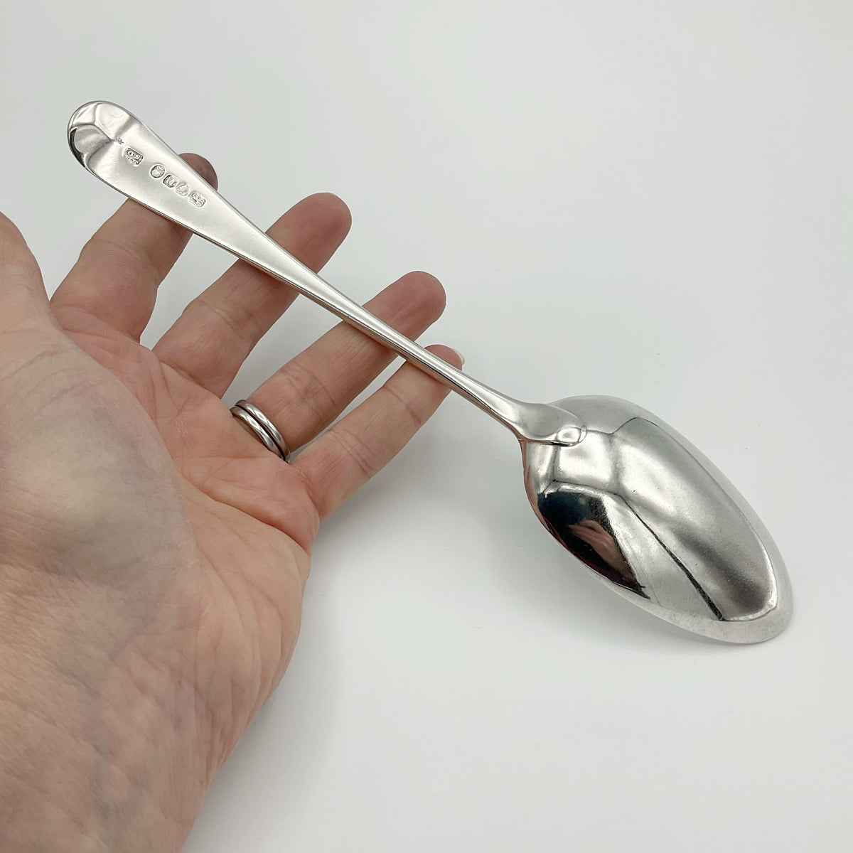 Antique Georgian 1788 silver serving spoon with ornate handle, from Beeches Vintage, showcasing intricate vintage craftsmanship.