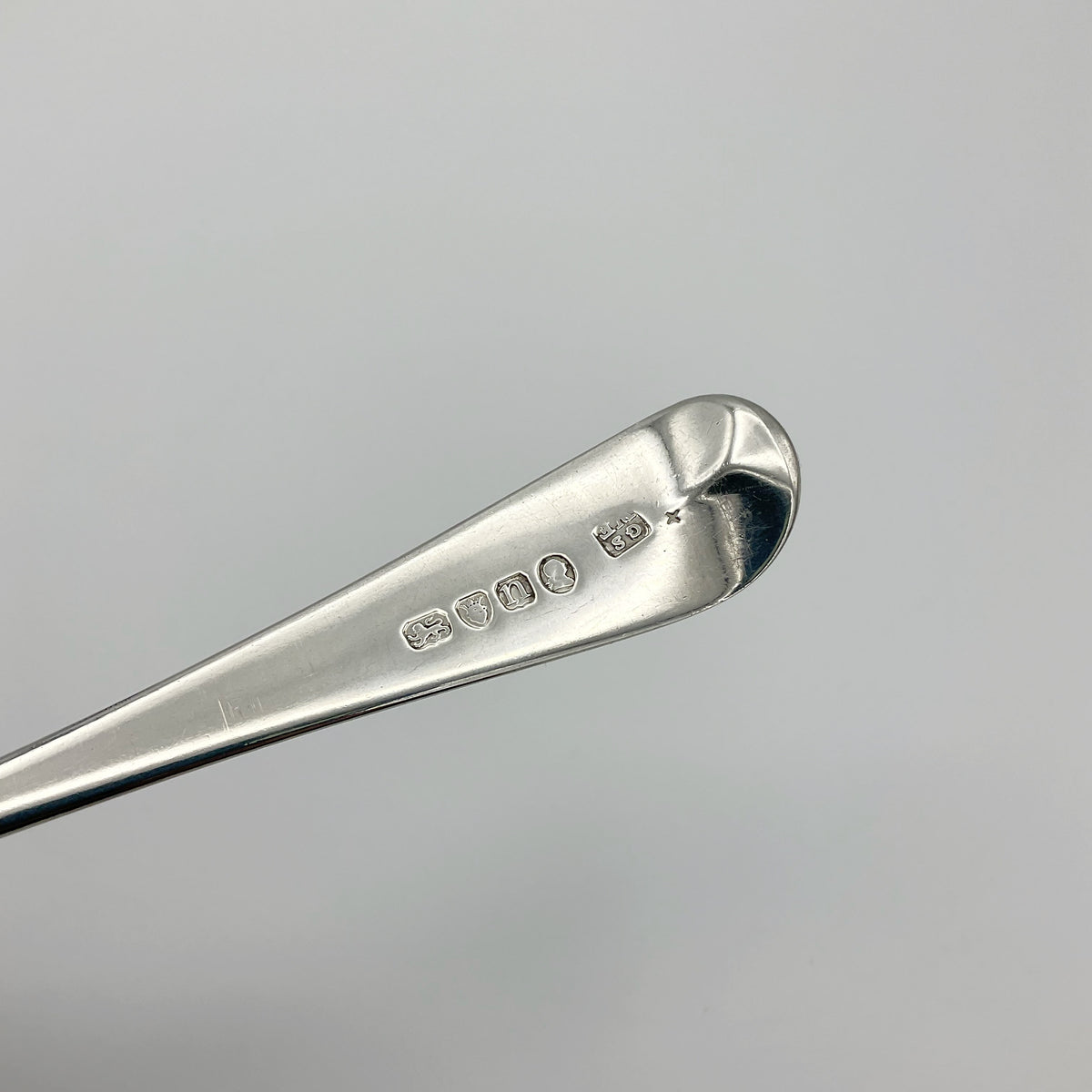 Antique Georgian 1788 silver serving spoon with ornate handle, from Beeches Vintage, showcasing intricate craftsmanship and historical design.