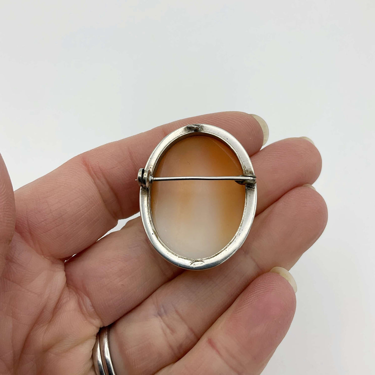 Back of Cameo Silver Brooch in a hand