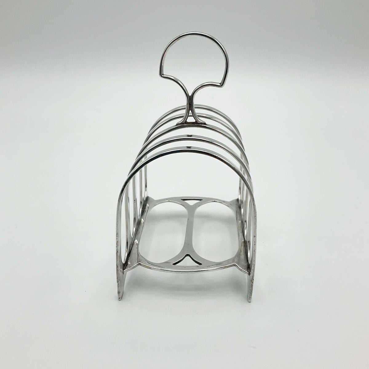 Antique 1912 sterling silver toast rack with intricate design, crafted by Beeches Vintage, showcasing vintage elegance and craftsmanship.