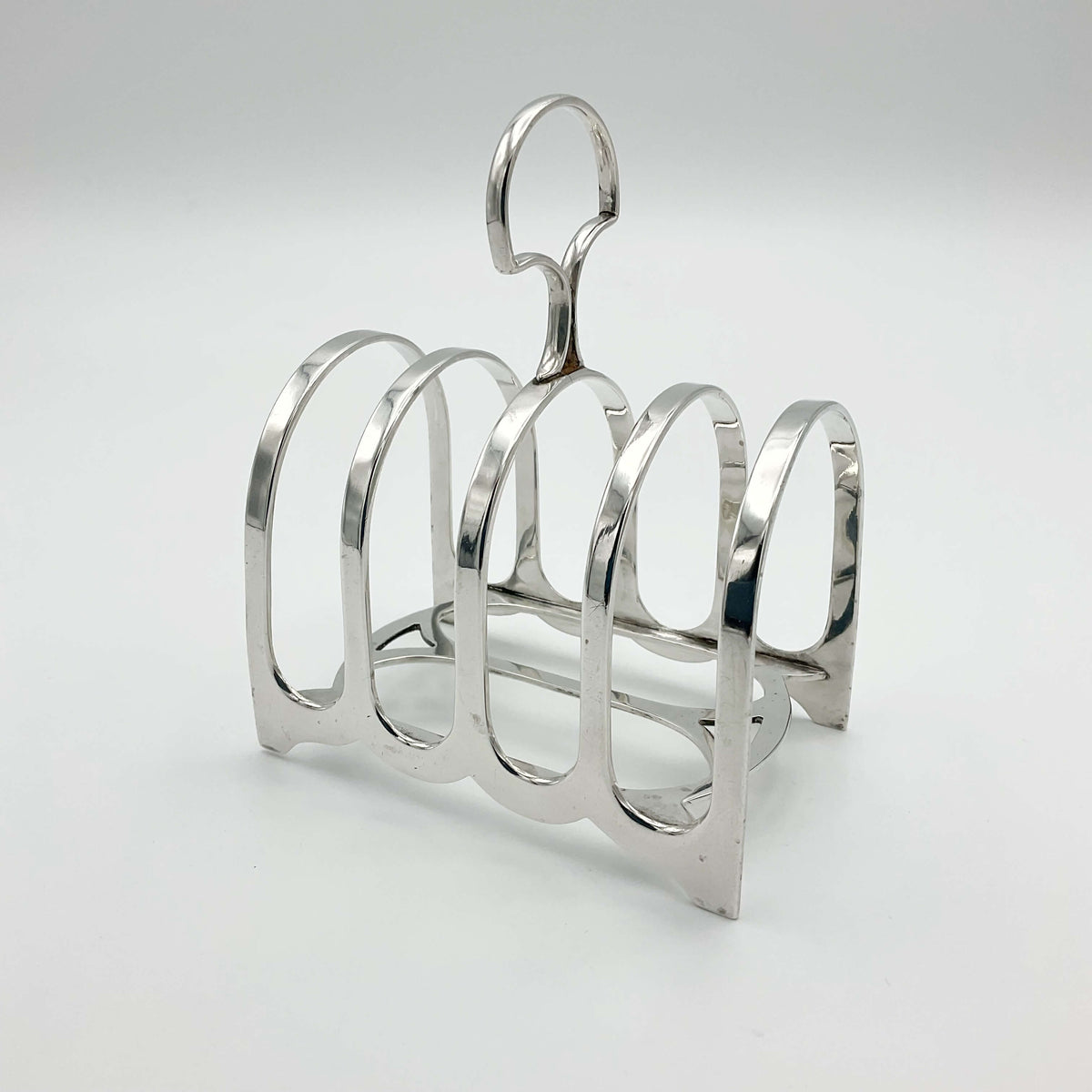 Antique 1912 sterling silver toast rack with intricate design, crafted by Beeches Vintage for elegant breakfast table display.
